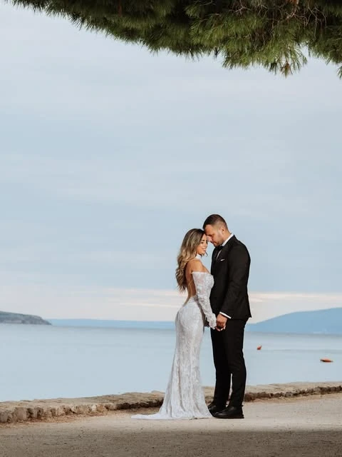 Bride and groom sharing a quiet moment beside the sea — wedding portrait by Nemanja Potkonjak